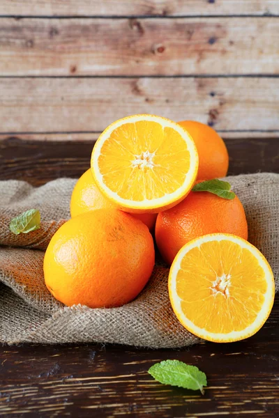 Fresh oranges on sacking — Stock Photo, Image