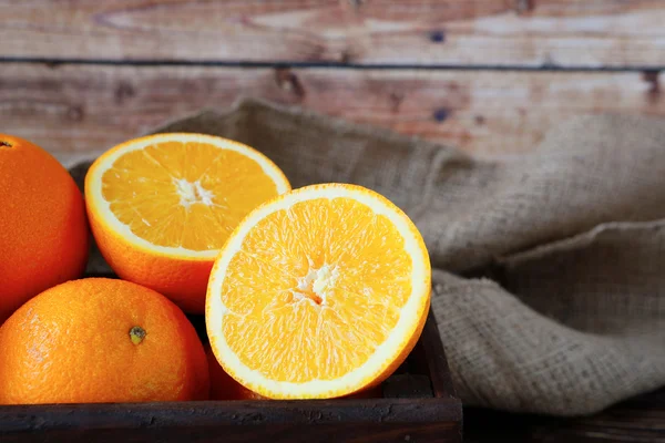 Ripe orange in a wooden crate — Stock Photo, Image