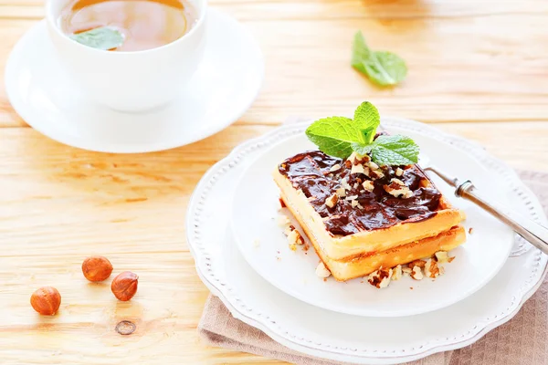 Waffles with chocolate and green tea for breakfast — Stock Photo, Image