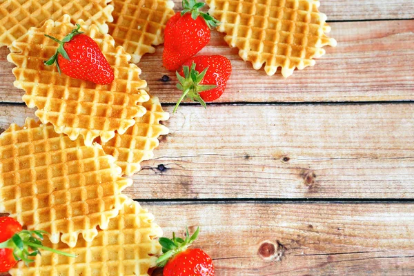 Waffles and strawberries on wooden background — Stock Photo, Image