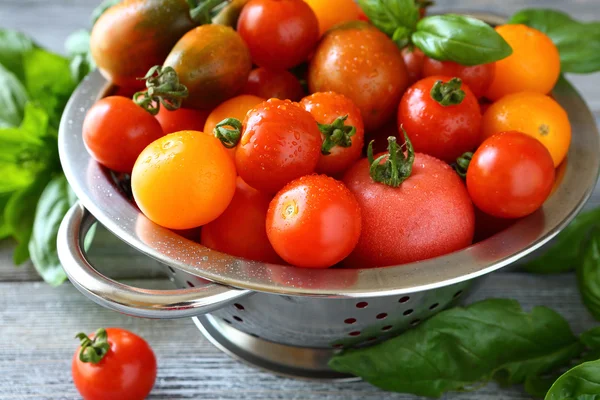 Fresh tomatoes in a metal colander — Stock Photo, Image