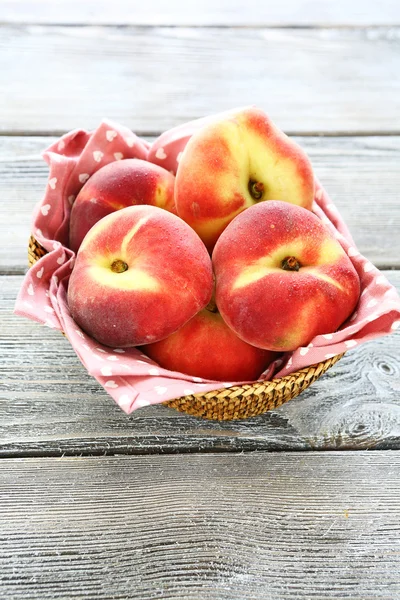 Fragrant peaches in a wicker basket, — Stock Photo, Image
