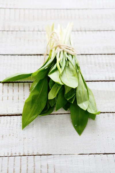 Bunch of garlic on white boards — Stock Photo, Image