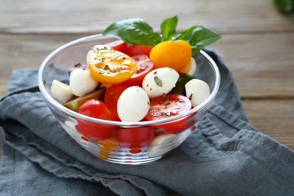 Salad with cheese and tomatoes in a bowl — Stock Photo, Image