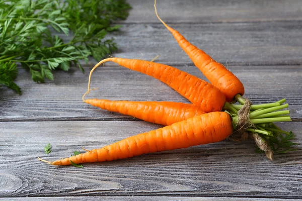 Fresh orange carrot on a wooden table — Stock Photo, Image