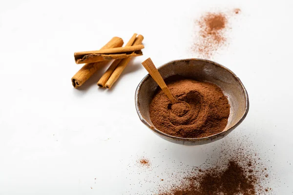 Cinnamon Sticks Powder Bowl White Surface Copy Space — Stock Photo, Image