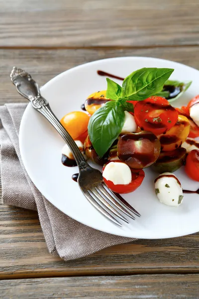 Caprese salad on a white plate — Stock Photo, Image