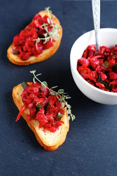 Bruschetta with pieces roasted vegetables — Stock Photo, Image