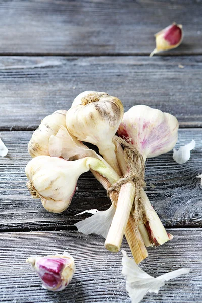 Fresh garlic on gray boards — Stock Photo, Image