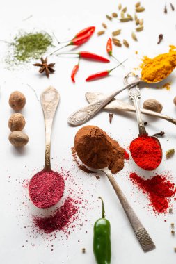 Tarçın, köri ve paprika tozu baharatının kapağı beyaz yüzey kimyon hindistan cevizi pişirme konsepti