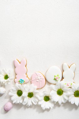Easter bunny, egg and flowers background top view