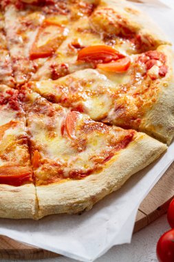 Close up of sliced tomato and meat pizza fast food concept