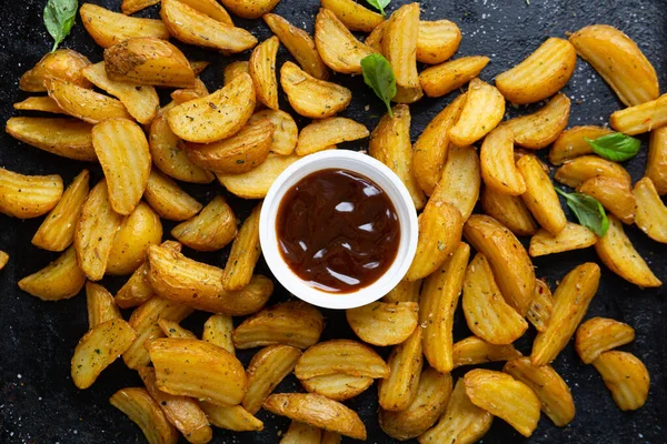 Top View Potatoes Wedges Bbq Sauce Black Surface — стоковое фото