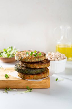 Vegan patties with chickpea and vegetables stack food light background