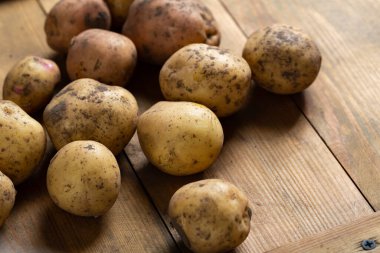 Fresh homegrown organic potatoes  on wooden table food closeup 