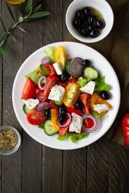 Top view of Fresh Greek salad o white plate mediterranean food