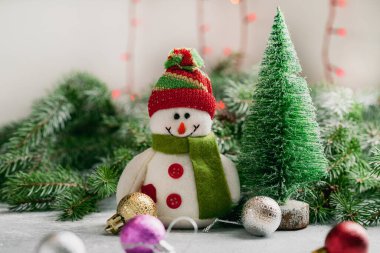 Christmas composition with snowman and green branches 