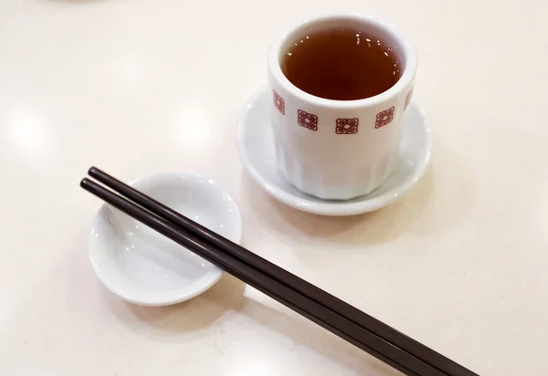 Chinese tea with a pair of chopsticks — Stock Photo, Image