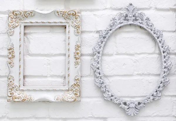 Vintage picture frames on white brick wall background — Stock Photo, Image