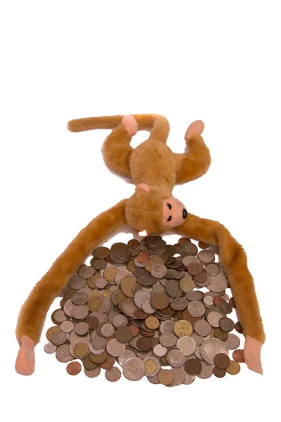 Pile of coins and a monkey — Stock Photo, Image