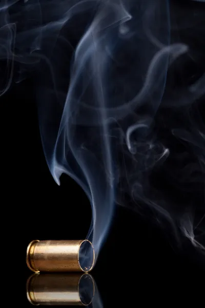 Smoking bullet casing — Stock Photo, Image