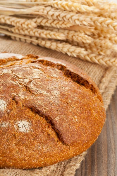 Loaf of bread with wheat ears — Stock Photo, Image