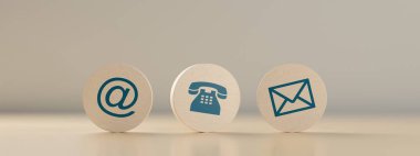 Wooden round telephone, envelope letter and e-mail symbols in a row on wooden table background, contact us symbols or banner, 3D illustration