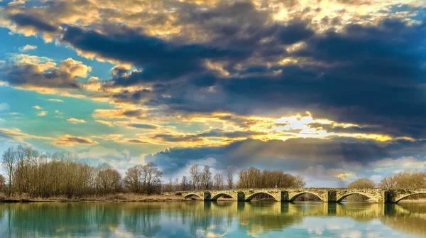 Pôr do sol numa ponte românica — Fotografia de Stock