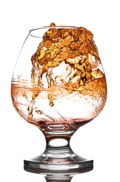 Whisky poured to glass from buttle with splashes — Stock Photo, Image