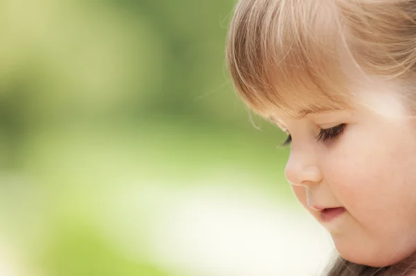 Face of little girl in the park — Stock Photo, Image