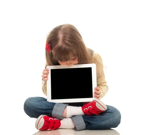 Cute little girl wearing jeans overall sitting on the floor with — Stock Photo, Image