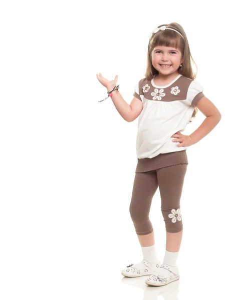 Cute little girl posing in the studio and point to somewhere or — Stock Photo, Image