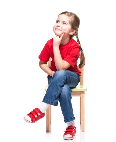 Little girl wearing red t-short and posing on chair — Stock Photo, Image