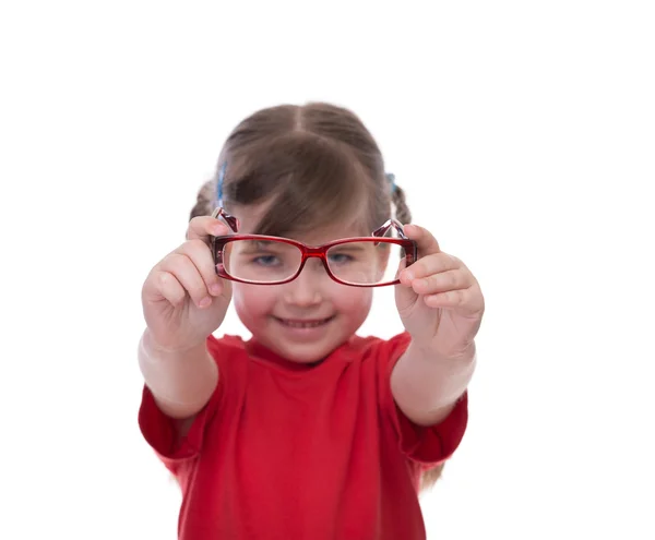 Cute little girl holding glasses and looking thru it — Stock Photo, Image