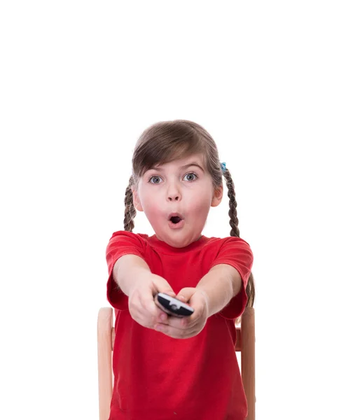 Very surprised little girl wearing red t-short and holding tv re — Stock Photo, Image