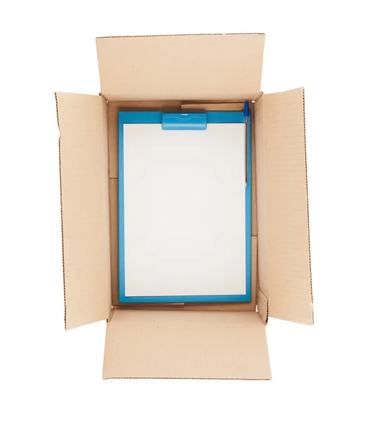 Top down view of open cardboard box with clipboard in it — Stock Photo, Image