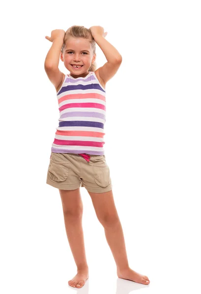 Cute little girl standing on white whith hands on her head — Stock Photo, Image