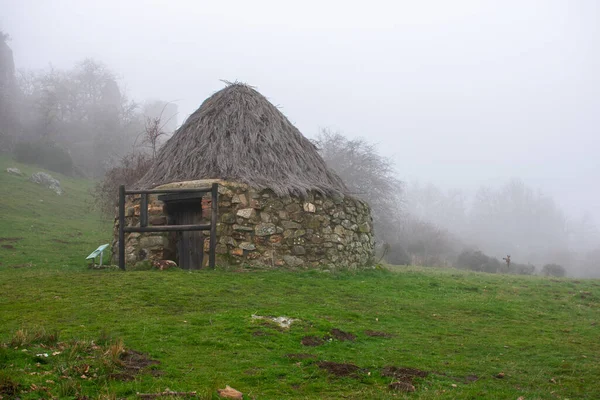 Una Antigua Casa Piedra Circular Con Techo Paja Las Montañas Imagen De Stock