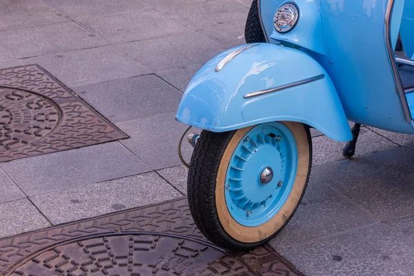 a blue vintage motorcycle front wheel