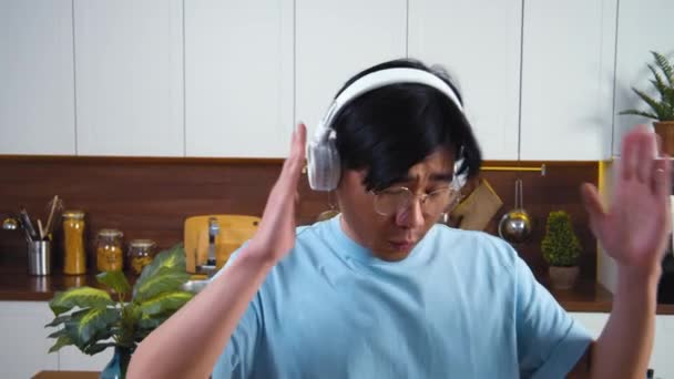 Joyful Asian Vietnamise Guy Wireless Headphones Home Kitchen Having Fun — Stock Video