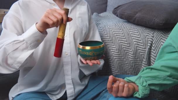 Two persons doing meditation or yoga at home. Using tibetan singing bowl. Modern family people take care about mental health, deal with depression and burnout. — Video Stock