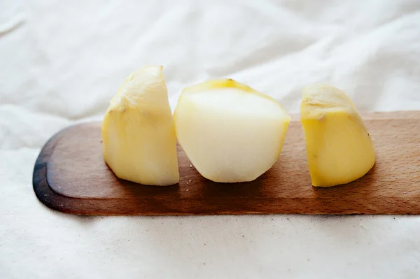 Old potatoes cooked on a wooden spoon — Stock Photo, Image