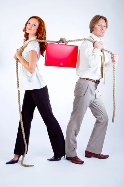Woman and man pulling rope with a case — Stock Photo, Image