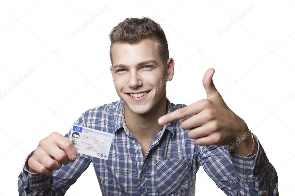 Young man showing off his driver license