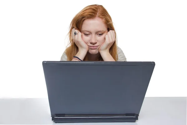 Young girl sitting in front of her notebook — Stock Photo, Image