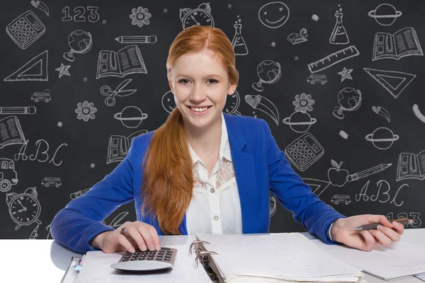 Young businesswoman is calculating and writing on a paper — Stock Photo, Image