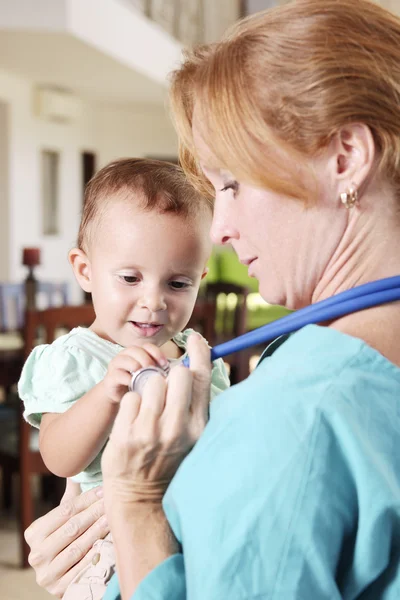 Nurse or doctor with an infant Stock Photo