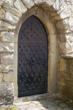 The door to the castle tower. The castle walls. Doors clad in sheet metal and nailed with steel studs