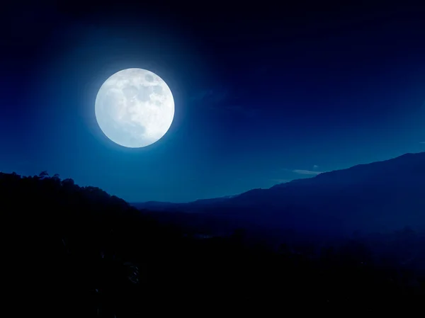 Full moon over mountain range. Night sky and mountain landscape