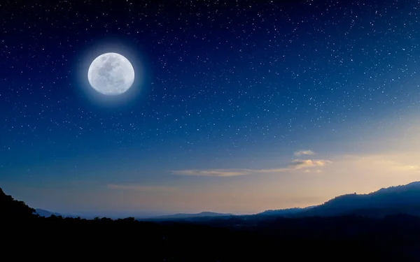 Night sky background. Moon above the mountains. Moon and stars nature background